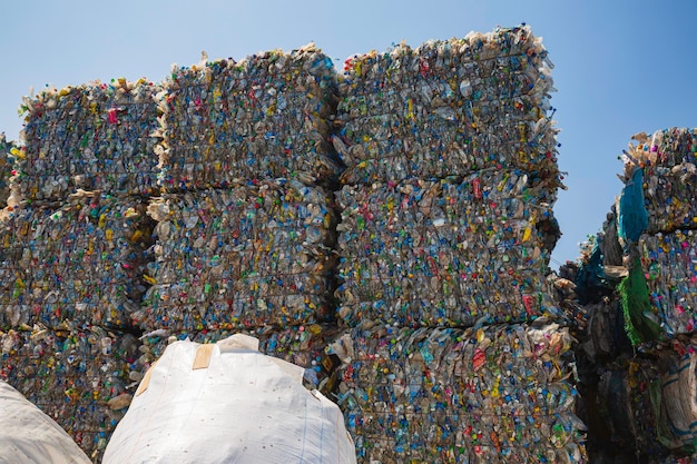 Big pile of waste plastic bottles in the factory to wait for recycling