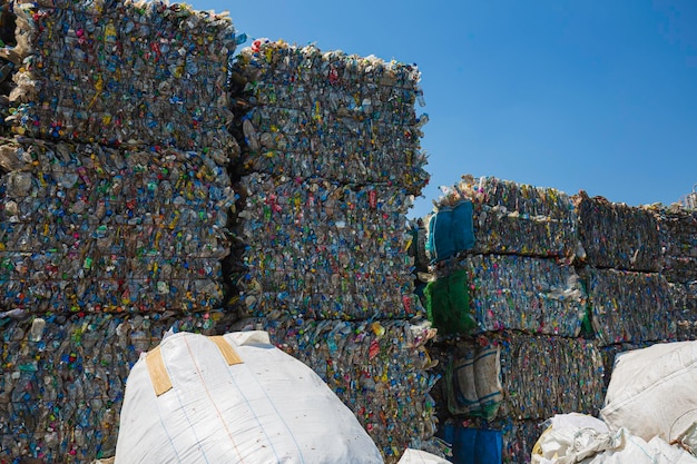 Big pile of waste plastic bottles in the factory to wait for recycling