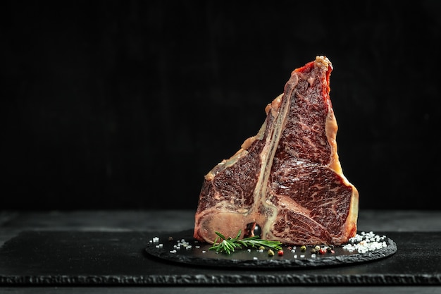 Big raw T-bone or aged wagyu porterhouse grilled beef steak with spices Ready to Cook