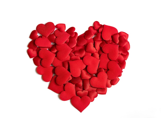 A big red heart made of small satin hearts on a white background