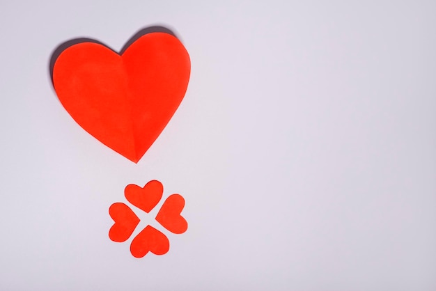 Big red heart and small hearts on gray background