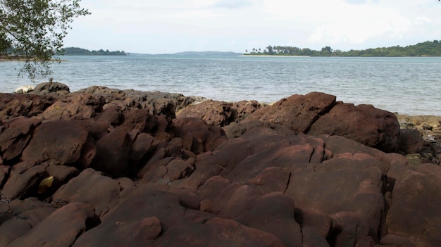 Big red stone formation at the sea shore natural look unique tropical beach in asia