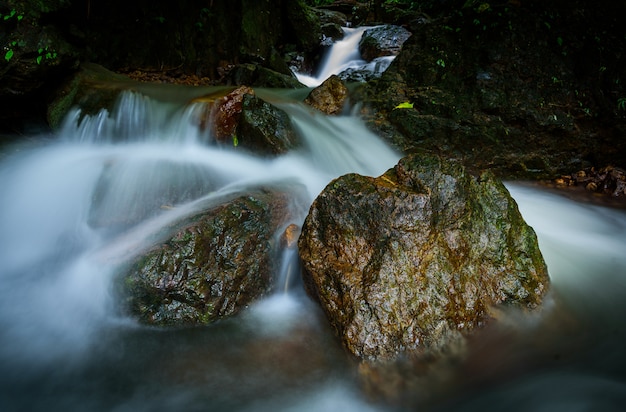 Big rock in the forest at Nangrong Waterfall, Nakhon Nayok province, Thailand with long exposure in the morning.