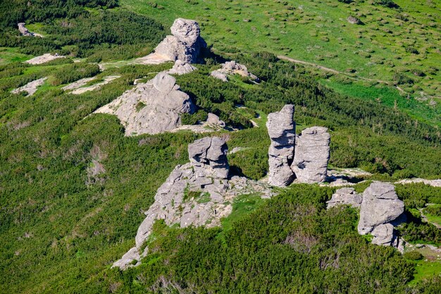 Big rocky vertical boulders on summer mountain