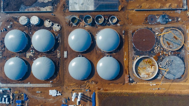 Big round storages field Oil metal huge tanks aerial shot