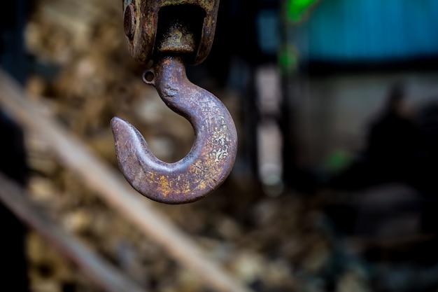 big rusty steel hook weighs