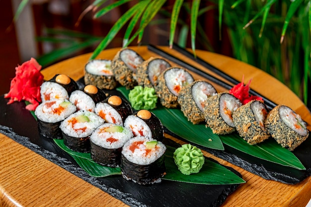 Big set of Asian food Sushi and rolls on a dark background