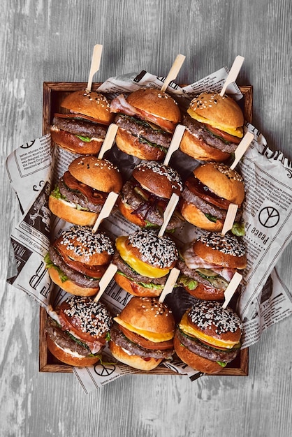 Big set of many hamburgers top view cheesrubogers beautifully laid out on a tray seth fast food food