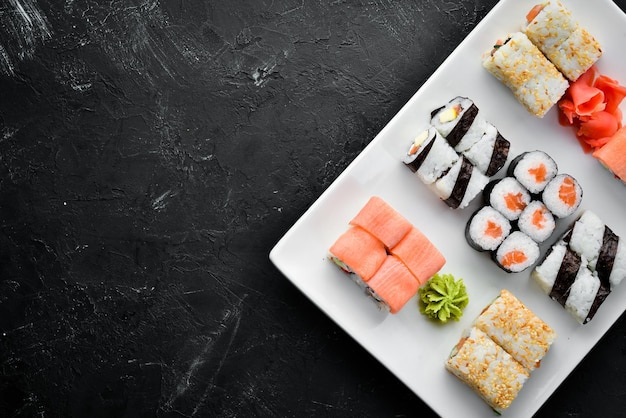 Big Set sushi with soy sauce and wasabi Free space for your text Top view On a stone background