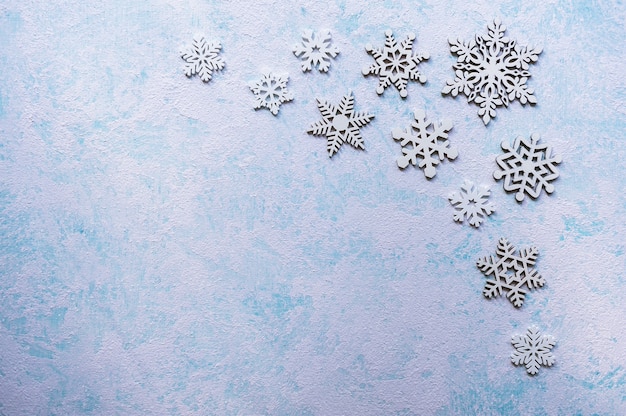 Big and small snowflakes on turquoise blue background. Abstract Christmas  background.