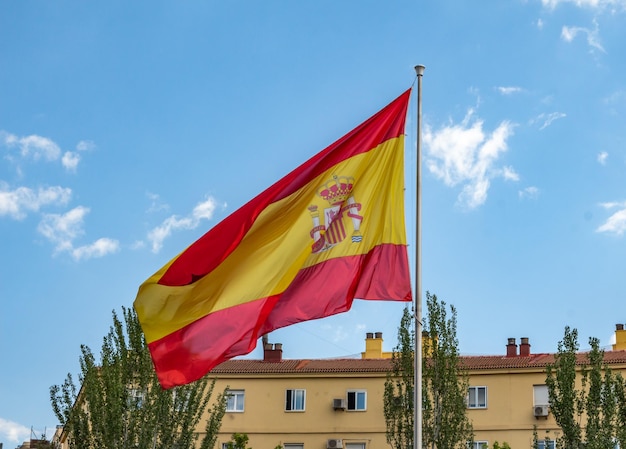 Big spanish flag waving in the air in Madrid