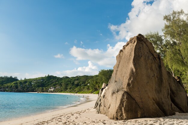 Big stone on sandy Seychelles beach landscape