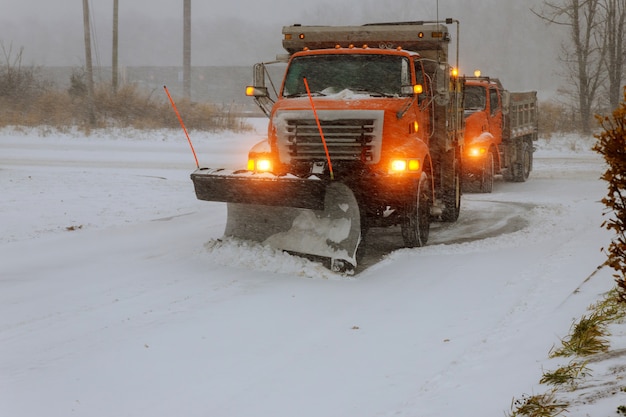 The big tractor removal snow street during snow blizzard