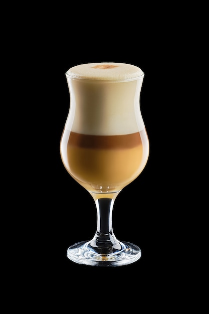 Big transparent glass with layered latte isolated on black background