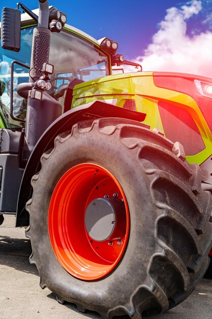 Big wheel of agricultural machine. Farming modern industrial harevesting field.