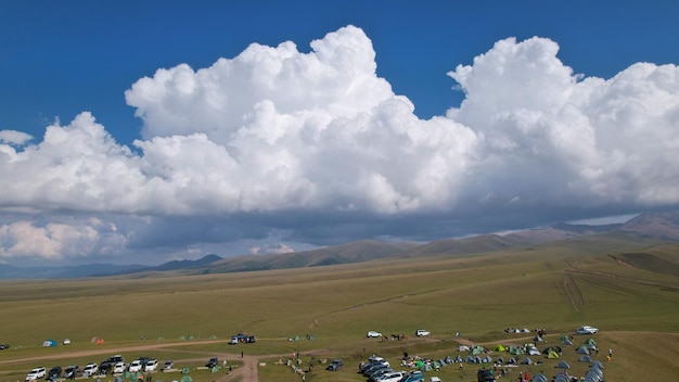 Big white clouds over green hills and mountains