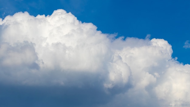 Big white curly cloud in the blue sky