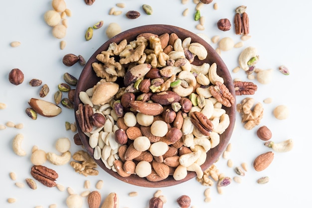 big wooden plate with a mix of useful nuts with copy space