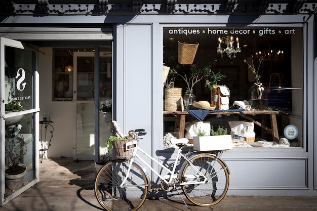 Bike with basket plants and decoration in front of the store vintage look