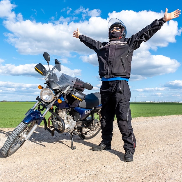 Biker stands near his motorcycle