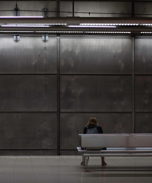 BILBAO SPAINMAY 5TH 2022 Vertical view of backwards sitting woman wating for the underground to come