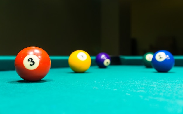 Billiard balls rolling on the green table