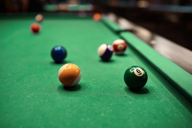 Billiard balls with different on green pool table. Selective focus, shallow depth of field