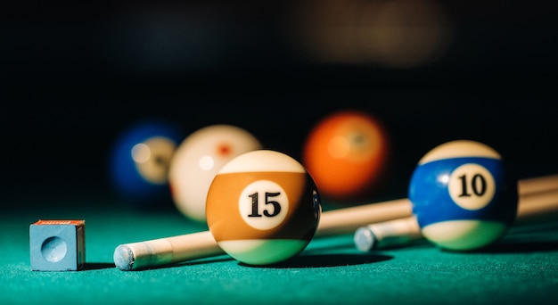 Photo billiard table with green surface and balls in the billiard club. pool game.