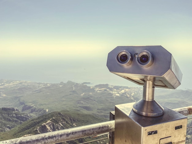 Binoculars on an observation deck made of gray metal sightseeing tour observing the view