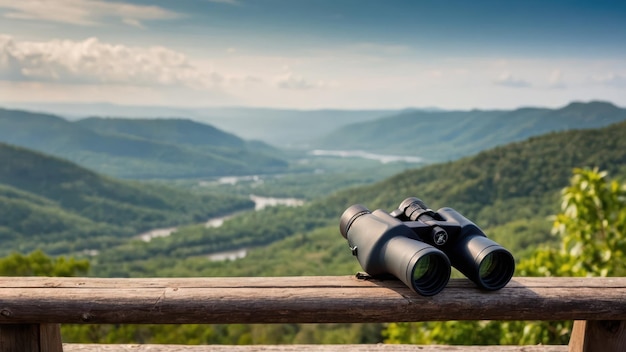 Photo binoculars on a wooden railing overlooking a scenic mountain and river landscape