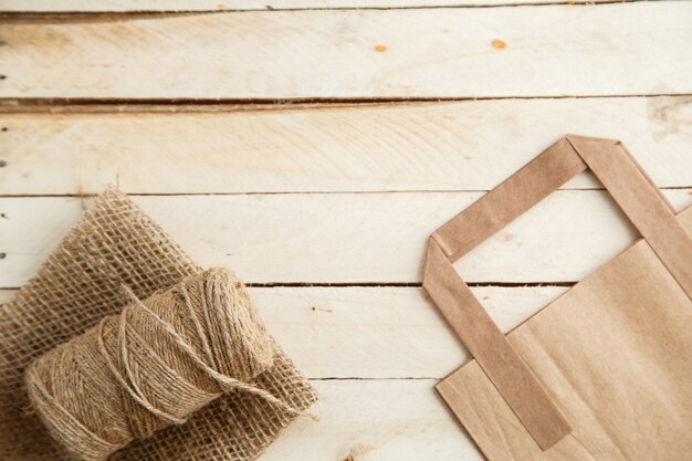 Biodegradable environmentally friendly cardboard bag on wooden background