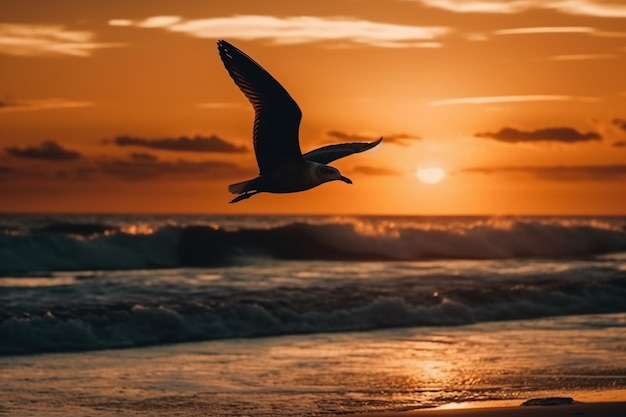 A bird flying over the ocean at sunset