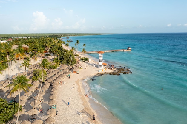 Bird's eye view of a beach with palms and a lighthouse in the Dominican Republic