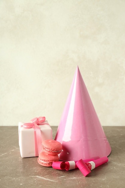 Birthday accessories on gray textured table, close up