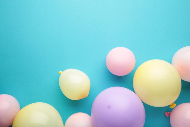 Birthday background with colorful balloons on blue background top view