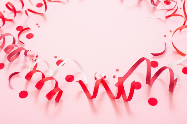 Birthday background with red serpentine on pink