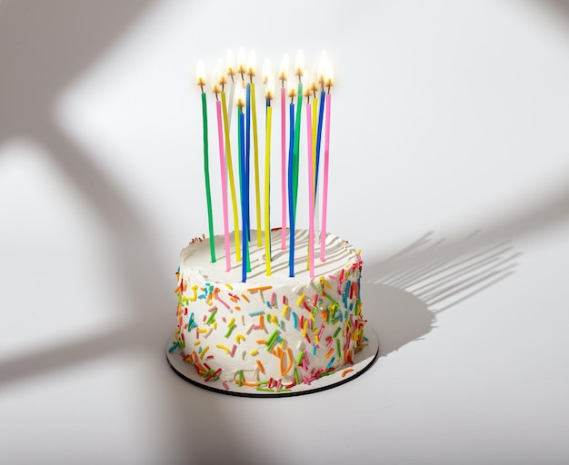 Birthday bento cake with high tall candles sunlight sunny day