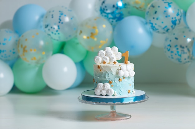 Birthday cake with candles and balloons