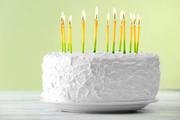 Birthday cake with candles on light background