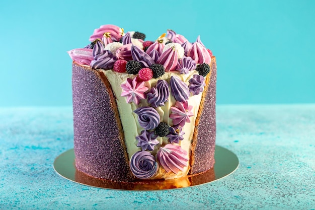 Birthday cake with lilac and pink meringues and marmalade berries