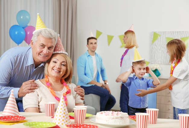 Birthday party Happy grandparents sitting at table