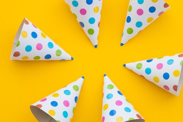 Birthday party hats on yellow background