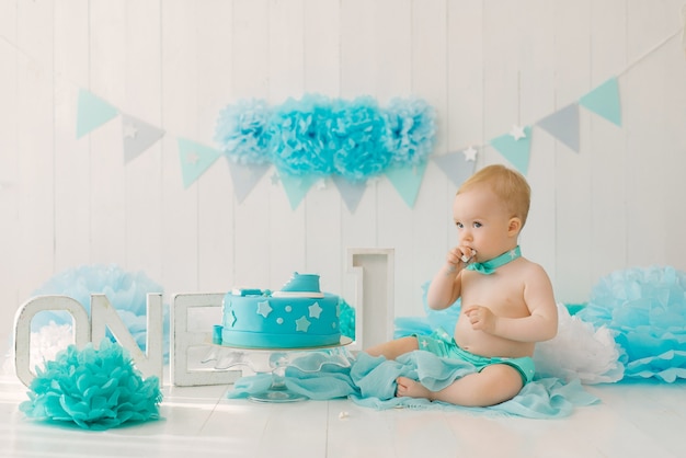 Birthday party for a oneyearold boy in blue and turquoise garlands and a cake holiday concept