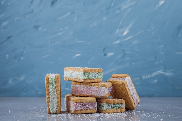 Biscuit sandwich filled with colorful marmalade on stone background. 