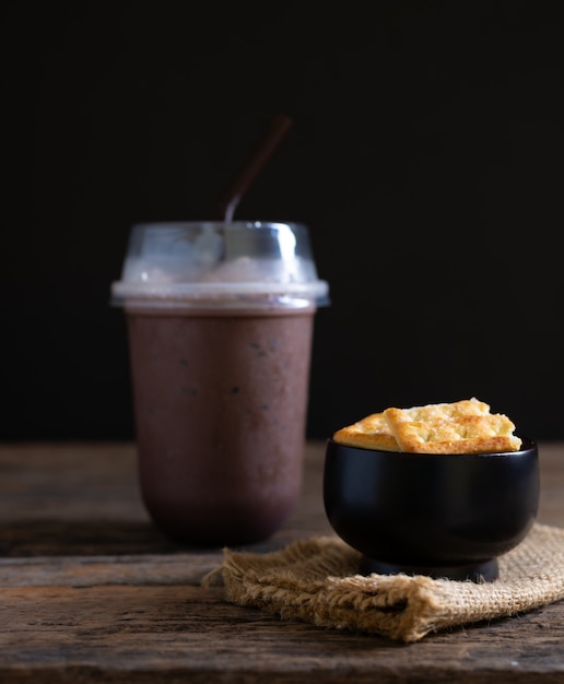 Biscuits with ice cocoa or chocolate on wooden