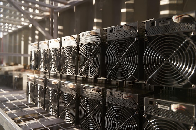 Bitcoin ASIC miners in warehouse ASIC mining equipment on stand racks for mining cryptocurrency in steel container Blockchain techology application specific integrated circuit units storage