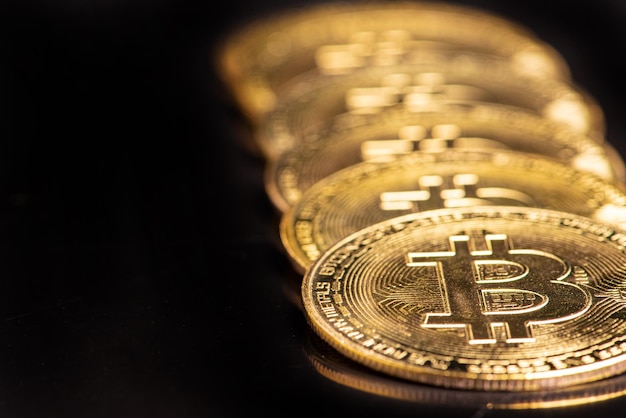 Bitcoin bitcoin coins placed on a dark reflective background selective focus