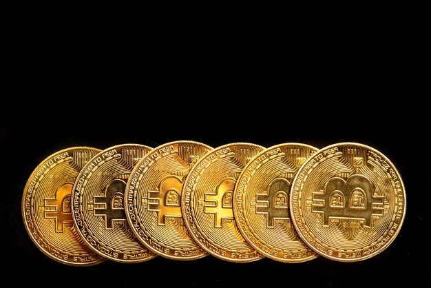 Bitcoin bitcoin coins placed on a dark reflective background top view