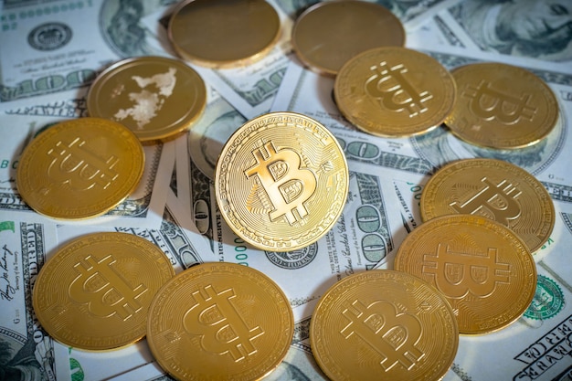 Bitcoin cryptocurrency coins and dollars bills in background