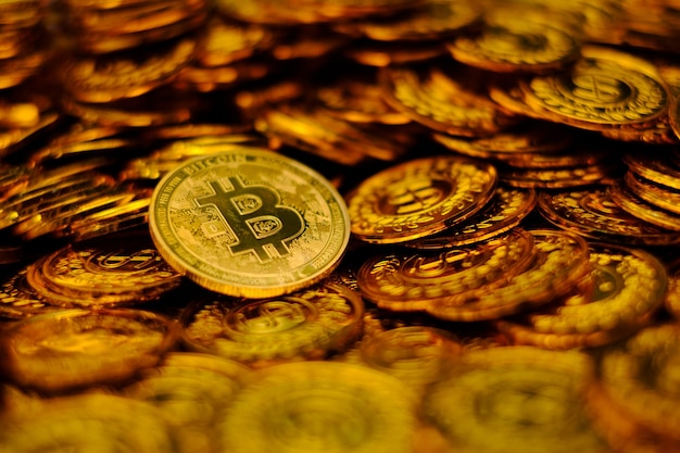 Bitcoin cryptocurrency on pile gold coins a lot of